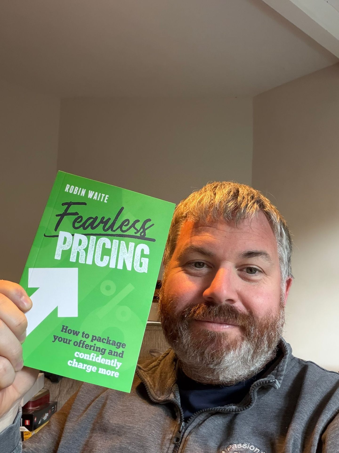 Bill Betts holding Fearless Pricing by Robin Waite