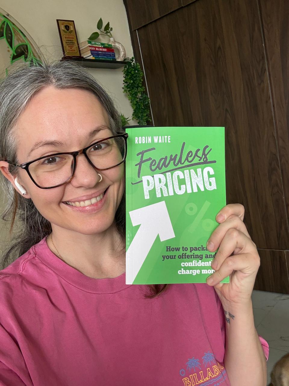 Amanda Boyce holding Fearless Pricing by Robin Waite