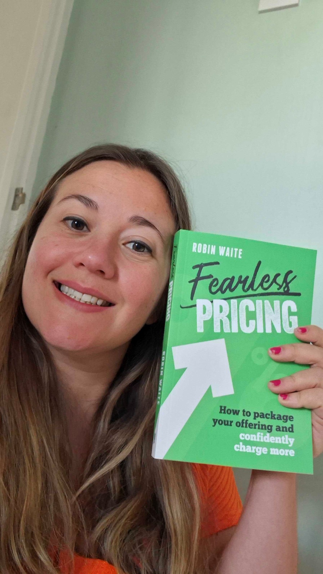 Happy Reader holding Fearless Pricing by Robin Waite