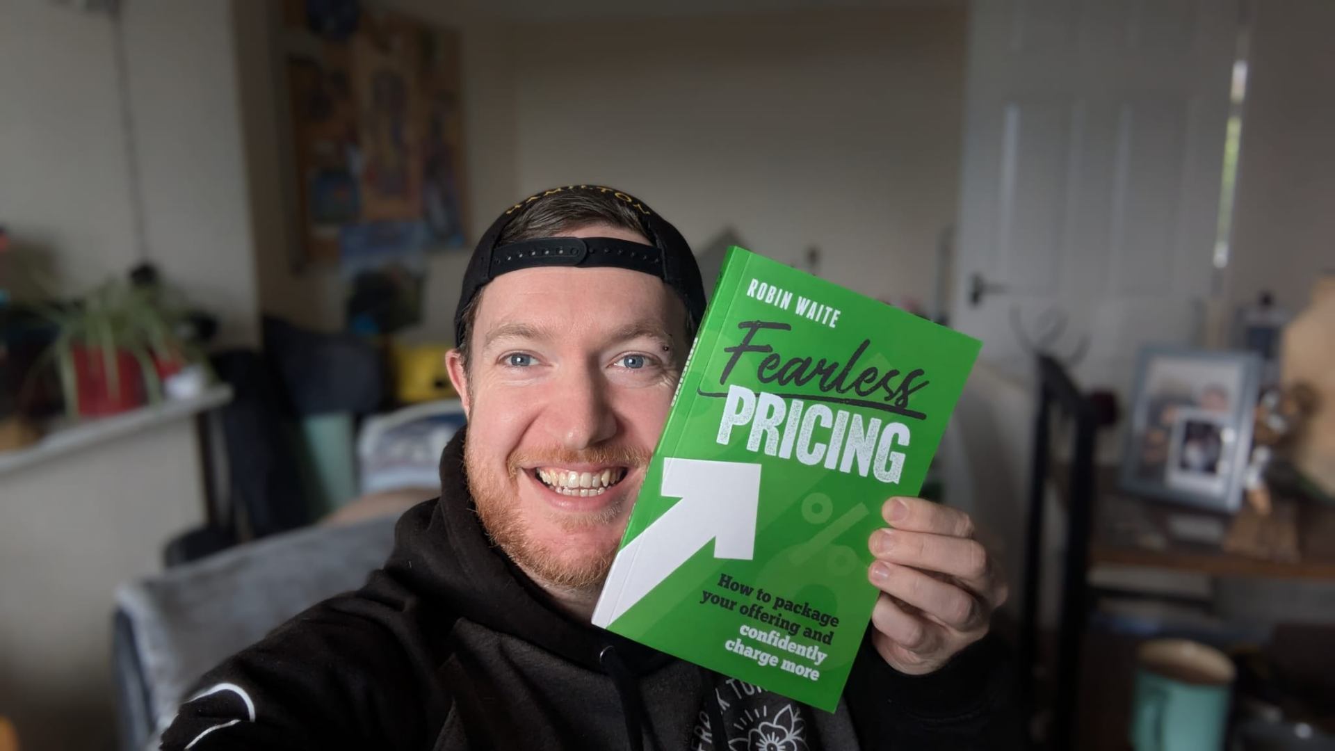 Daniel Willcocks holding Fearless Pricing by Robin Waite
