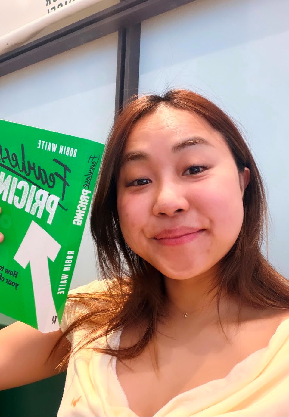 Hannah holding Fearless Pricing by Robin Waite
