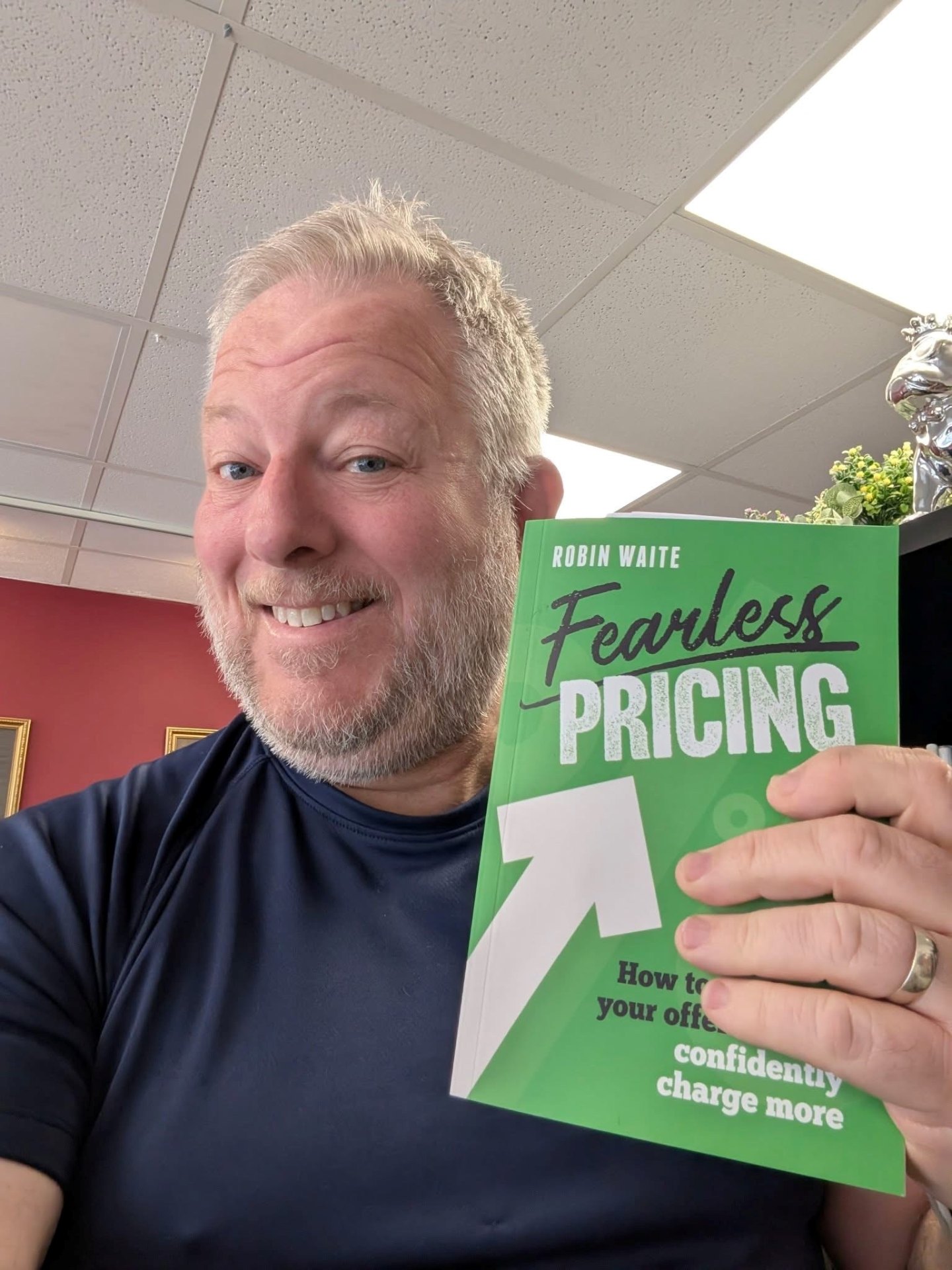 Happy Reader holding Fearless Pricing by Robin Waite